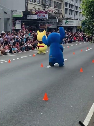 Pikachu outruns Stitch in a playful mascot race on Session Road in Baguio, Philippines