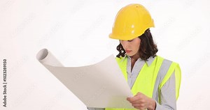 Woman architect examines blueprint drawing unrolling sheet on white background. Busy female in protective uniform and helmet engages in construction planning