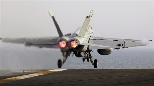 Fighter jet falls off aircraft carrier into the ocean