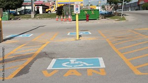 van handicap parking space with van written text below handicap symbol, traffic cars vehicles and trucks passing in background Stock Video
