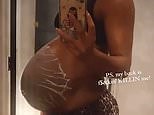 Kelly Rowland shows off her baby bump while using belly mask