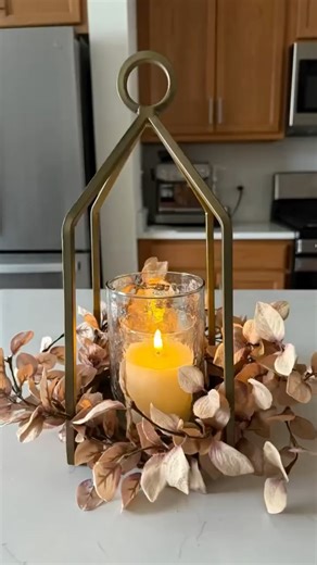 This beige candle ring and our modern brass lantern are a match made in decor heaven.