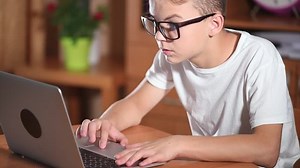 clip-18042493-teen-boy-glasses-doing-homework-school-home