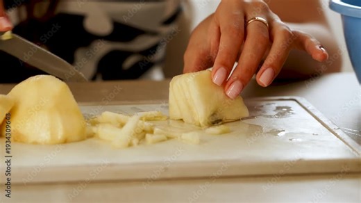 Slicing a pear in a kitchen with clear focus on cutting technique and hand movements