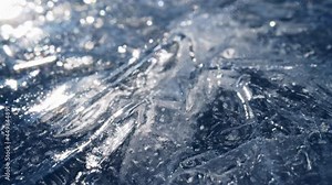 Sliding shot of real transparent ice. Camera moves over the ice of a frozen river or body of water. Climate change concept, ice melting