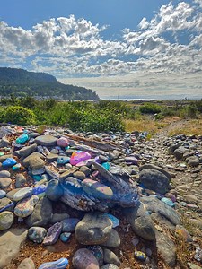 Painted Rock Beach in Seaside, Oregon, is a special place where visitors can enjoy a colorful collection of hand-painted rocks 🎨🪨. The tradition began when a local family started painting rocks and placing them along the beach path to share uplifting messages and brighten the area ✍️✨. Since then, visitors and locals have continued adding their own painted stones decorated with artwork, names, and positive words 🖌️💬. Today, the beach features hundreds of these unique rocks, creating a creati