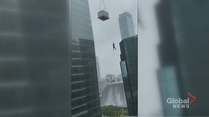 Videos show construction worker dangling from crane in downtown Toronto