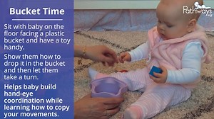 Help baby learn how to copy your movements! Show your baby how to do a simple activity, such as dropping a toy into a bucket. Then encourage them to do it on their own! This 7-9 month baby activity also helps to develop baby's hand-eye coordination skills. ➡️ Play more 7-9 month baby games: https://pathways.org/growth-development/7-9-months/games | Pathways.org