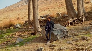 View of handsome boy walking in autumn nature