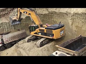 Caterpillar 385C Excavator Loading Trucks