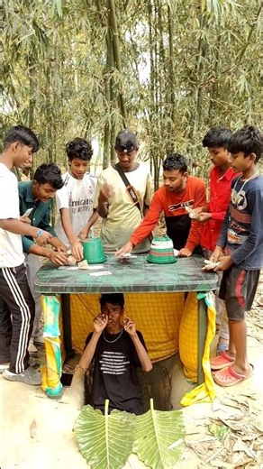 The boy under the table is cleverly changing the ball and sending people flying.