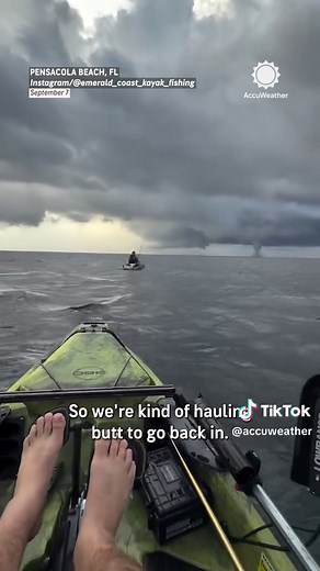 "Absolutely insane." A fisherman in a kayak captured a massive watersp... | waterspout