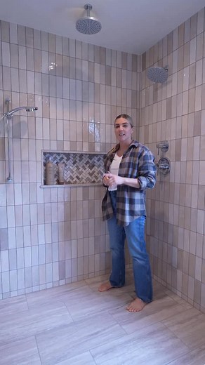 Want a cleaner, seamless shower look? Using quartz in your niche instead of tiled grout lines keeps everything looking polished with minimal upkeep. We love these smart remodel solutions. | Lets Remodel