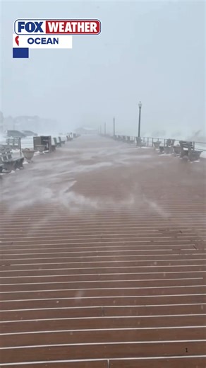 COASTAL CHILL🥶❄️: Strong winds blow snow across the boardwalk in Ocean Grove, NJ, reducing visibility as a powerful storm slams the Northeast. FOX Weather has you covered with the latest updates as this massive storm continues to impact millions. #snow #wind #nj #oceangrovenj #FoxWeather | FOX Weather