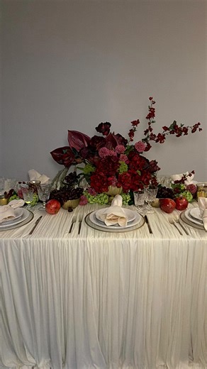 Event and Wedding Planning on Instagram: "Watch me set up this tablescape at home. Im obsessed with the table drapery…I love the ruffles movement, the burgundy and the green keeps it fresh and alive. What do you think? I’m not a florist but I think it turned out pretty good. I created the arrangements myself. #flowers #weddingdecor2026"