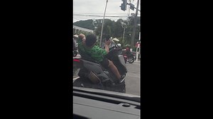 Tourist lies back on rented motorcycle while posing for selfies