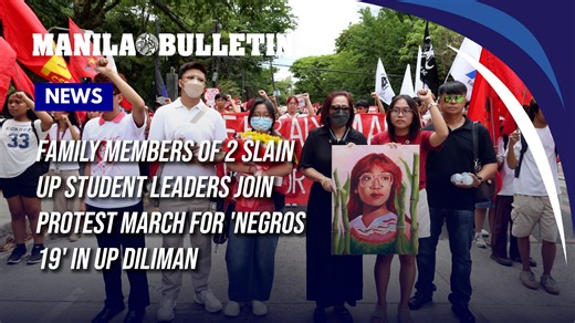 Family members of 2 slain UP student leaders join protest march for 'Negros 19' in UP Diliman