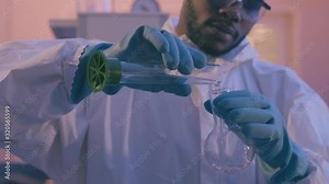 African scientist pouring liquid from beaker into Florence flask in laboratory