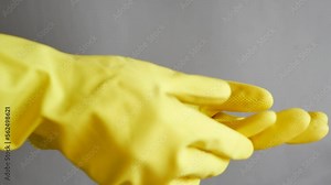 men wearing a yellow color cleaning gloves