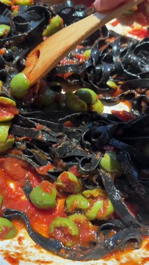 Pantry puttanesca with handmade squid ink pasta because I had absolutely nothing in my fridge. 1/4 cup olive oil, half a tube of garlic paste, a whole tube of onion paste, a large spoonful of Calabrian chili paste, and a whole can of anchovies melted down. Added half a large can of tomatoes and half a jar of torn olives with a splash of olive juice, let it simmer, then tossed with fresh squid ink pasta and pecorino. Salty, spicy, briny!!