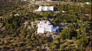 Aerial birds eye view video taken by drone of Monastery of Saint John the Theologian where he wrote the book of Revelation, Patmos Island, Dodecanese, Greece