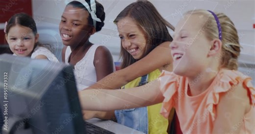 Four girls typing one reaching monitor peers leaning and pointing, sharing discovery in education