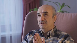 The old man prays looking at the sky with hope and faith. Old man with faith praying at home.