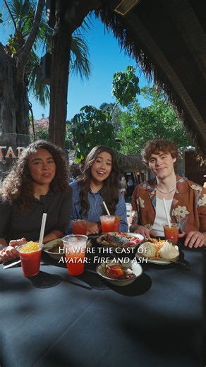 Bailey Bass, Trinity Bliss, and Jack Champion enjoy a Pandoran feast at Pandora - The World of Avatar in Disney’s Animal Kingdom. Experience Avatar: Fire and Ash in theatres and IMAX December 19. Get tickets now: Fandango.com/AvatarFireandAsh | Avatar
