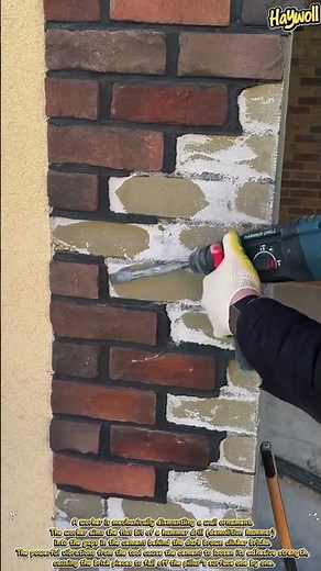 Dismantling the clinker brick layer on a building pillar using an electric hammer dril