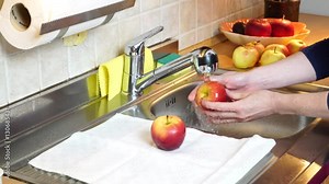 Woman hands washing fresh apple in kitchen under water stream. Wash fruits before eating. Protect health 4K ProRes HQ codec
