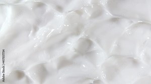 Motion of the Liquid cream, white cosmetic texture with rotation. Contouring, Make up smears background. Beauty skincare product sample. Slow motion. Top view. 4K UHD video. High quality 4k footage