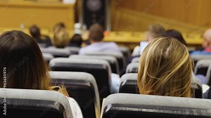 College students class with the professor in the auditorium, audience at the conference hall listens to lecturer, lecture seminar together listen to teacher, university classroom with faculty member