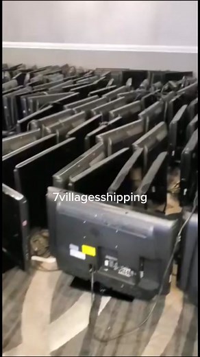 Flat-Screen TVs Stacked in a Shipping Warehouse