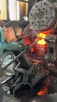 Inside the forging factory Workers unite transforming steel into bearing rings with air hammer