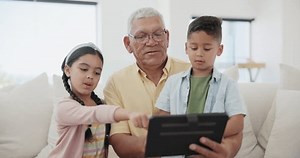 Relax, kid or grandpa with tablet for elearning or studying for remote learning education on sofa. Family, siblings talking or grandfather with kids reading ebook or streaming video or movies at home