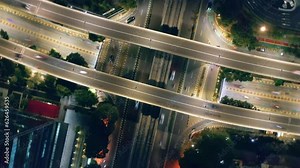 Top-down rotating timelapse of busy overpass intersection at night in Kuningan city, Jakarta - Indonesia