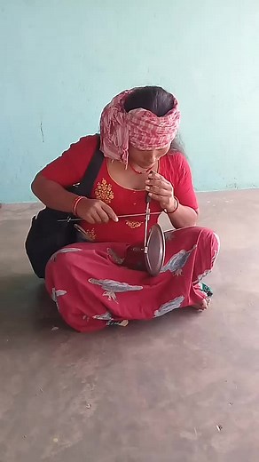 Traditional Thread Spinning by Women in Red Attire