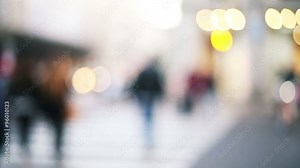 anonymous people crossing the street in a out of focus and blurred background