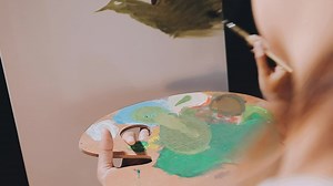 Attractive young woman attending a painting workshop, having fun, create an inspired art work at art studio