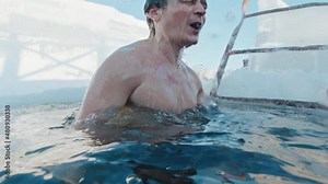 Ice swim. Man swims in the icy water and immerses into the cold water