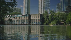 People sailing in a boat on the river of a city - Free Stock Video