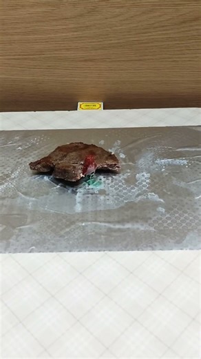 Lego man is eating meat.