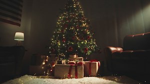 Twinkling christmas tree in the living room with gifts - Free Stock Video