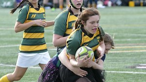 UVM women's rugby plays match in prom dresses