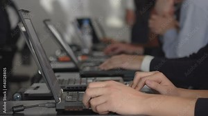 Many students in school using computer in classroom Full HD