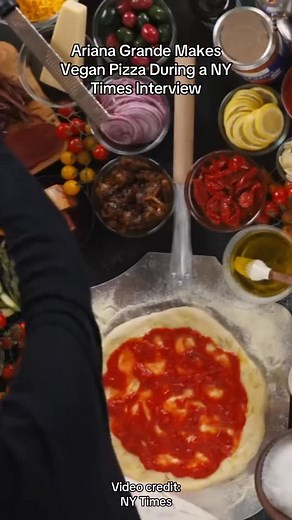 @arianagrande making a vegan pizza on camera? Yes, chef. 🍕 In her new New York Times interview, Grande hand-presses the dough, loads it up with vegan mozzarella, and keeps the pineapple far away (her hard no—she does not negotiate). While cooking, she also shared a story about making her Wicked costar @jbayleaf a trumpet-mushroom snack with vegan pesto, plus ordering vegan sushi from @planta Queen for the two of them. Ariana’s been vegan for years, and with Wicked: For Good newly released, we’r