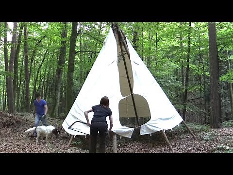 Setting up a teepee in the forest