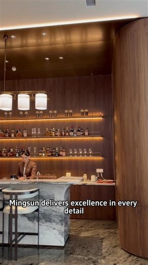 Luxury Hotel Bar Design: Seamless Integration of Custom Metalwork & Backlit Shelving