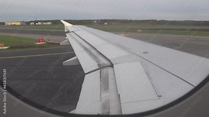 Stockholm, Sweden An airplane wing of an airliner on the tarmac at Arlanda Airport is ready for takeoff.