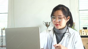 Healthcare and doctor's medical document file concept, Asian Doctor working with stethoscope, online record patient prescriptions clipboard, input information to laptop computer on desk hospital room
